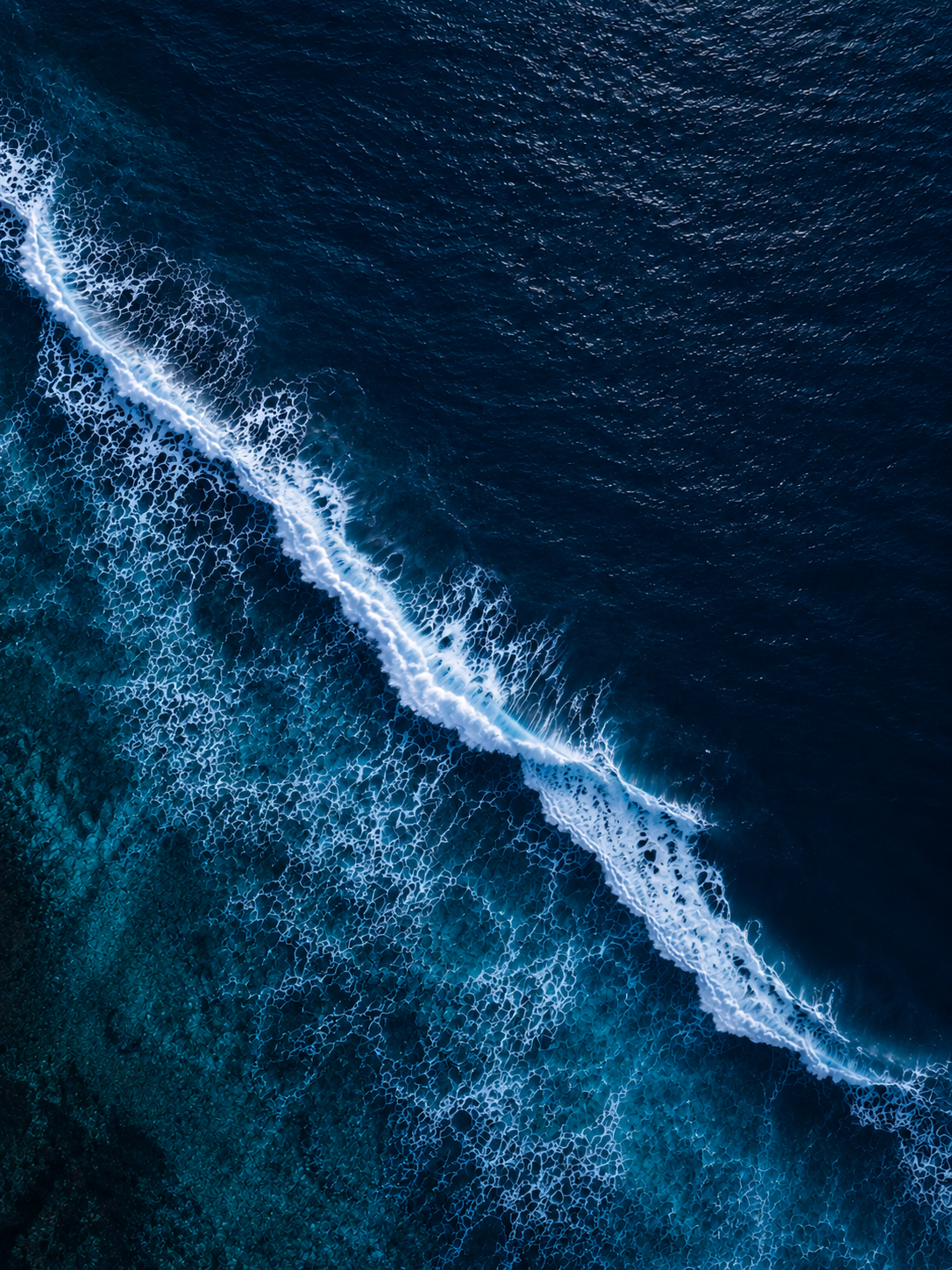 Aerial view of ocean waves at dawn